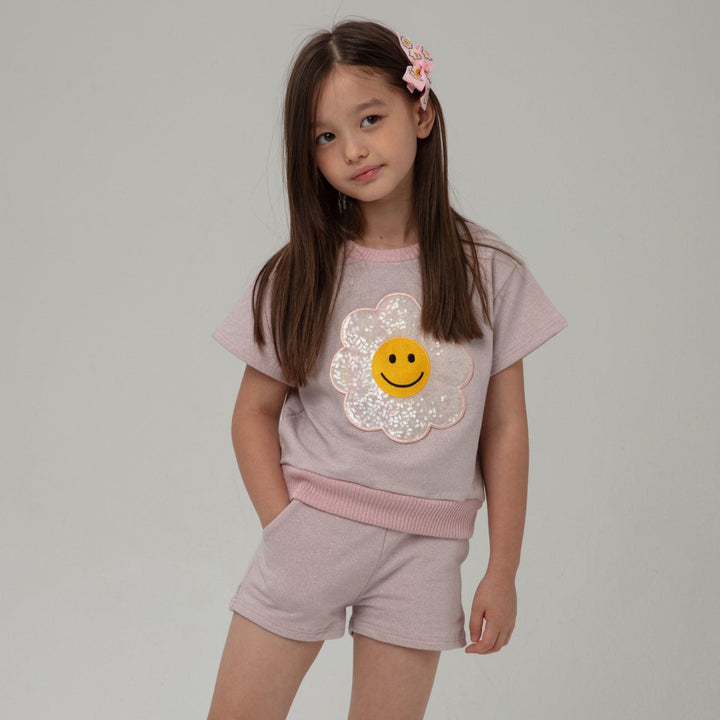 little girl modeling the pink metallic outfit with daisy applique . shorts are a nice length and hit mid thigh
