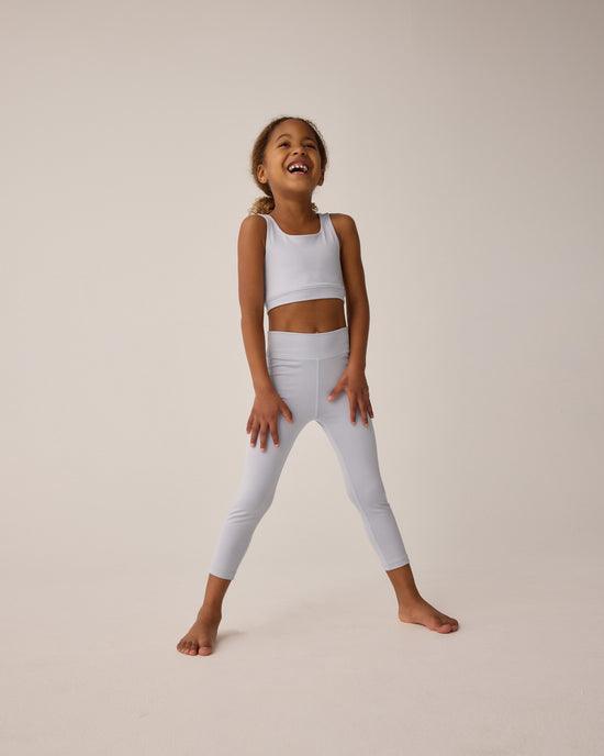 young girl modeling the light blue leggins and coordinating cropped top