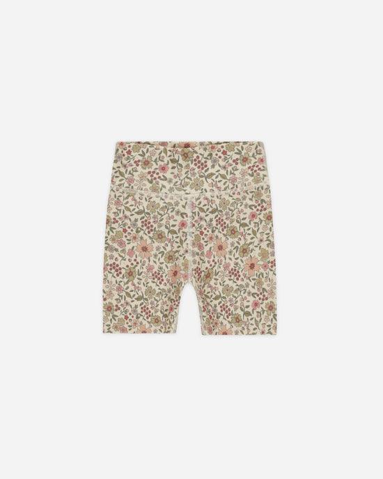 bike shorts with a sage green, peach and pink floral design. 