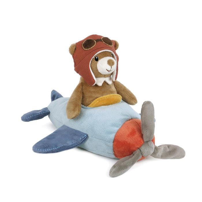 brown bear sitting in light blue plane with flying cap and goggles. 
