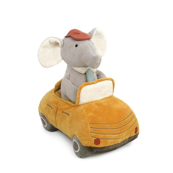 plush elephant sitting in a yellow car. 