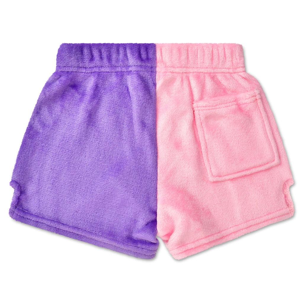 plush shorts in color blocking: one leg is pink and the other is purple. the pink leg has a pocket on the back. 