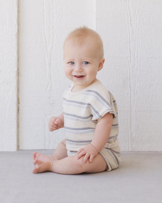 baby modeling the knit sweater set in blue and gray stripes