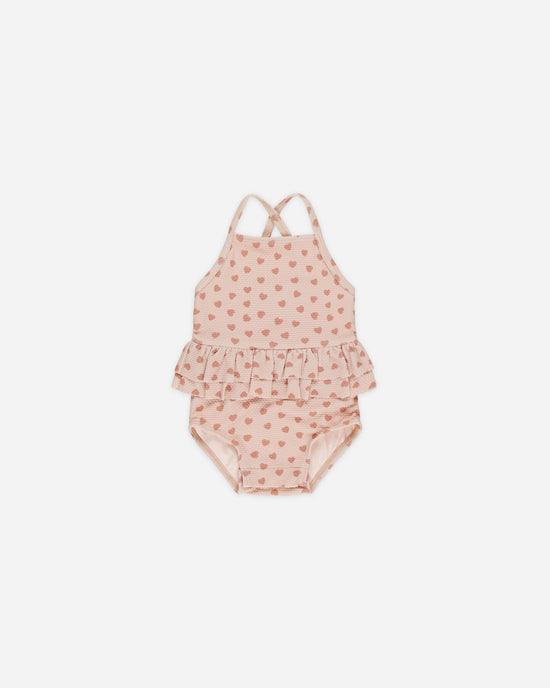 one piece baby girl swimsuit with peplum ruffle and tiny pink hearts all over. 