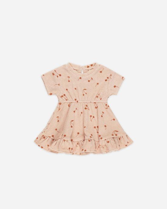 terry cloth dress, peach/pink color with a ruffle on the bottom with small cherries all over the dress. 