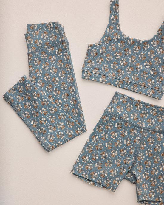 this picture shows the deep blue legging and floral pattern on the legging better. it also shows the sports bra and shorts in the same pattern. 