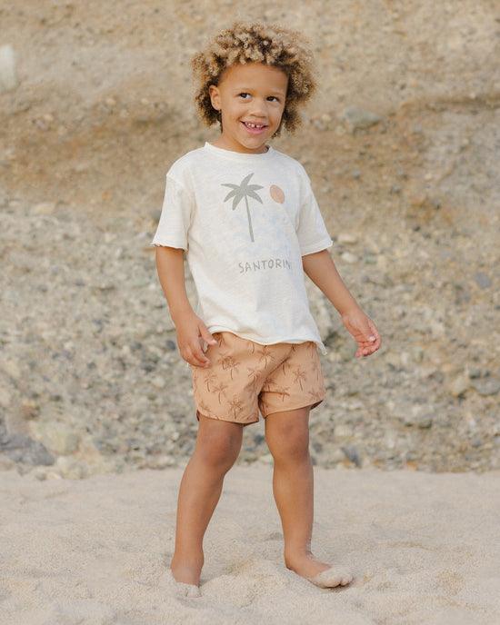 boy wearing relaxed fit t-shirt with santorini written on it across the chest. 