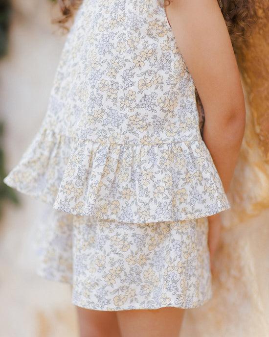 this is a close up of the pastel floral pattern in yellows, blues and muted sage. 