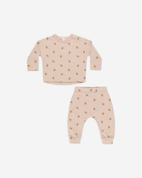 baby girl 2 piece holiday set in a dusty rose color with tiny gingerbread people all over it. long sleeve top and pants. 