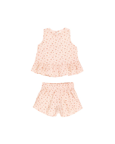 girls set with a peach base color and tiny red cherries all over the set. a peplum at the bottom and elastic waist at the shorts. 