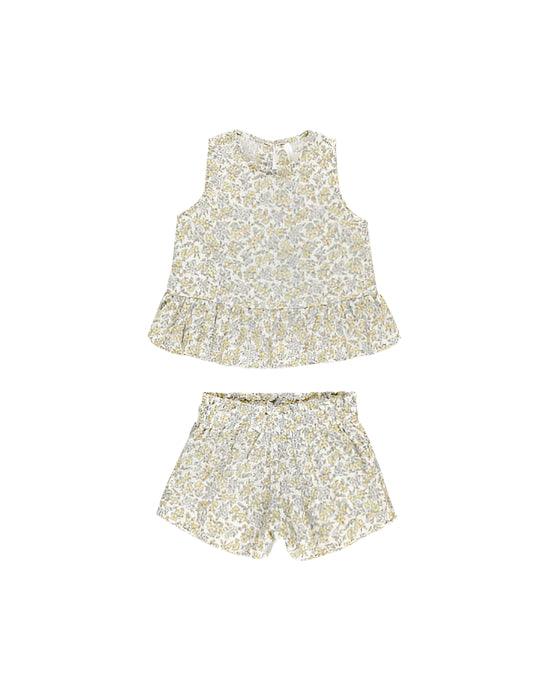 girls set with pastel yellow and blue floral pattern on it. top has a peplum bottom and shorts have an elastic waist. 