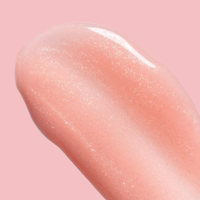 Close-up of a pink lip balm stick on a pink background