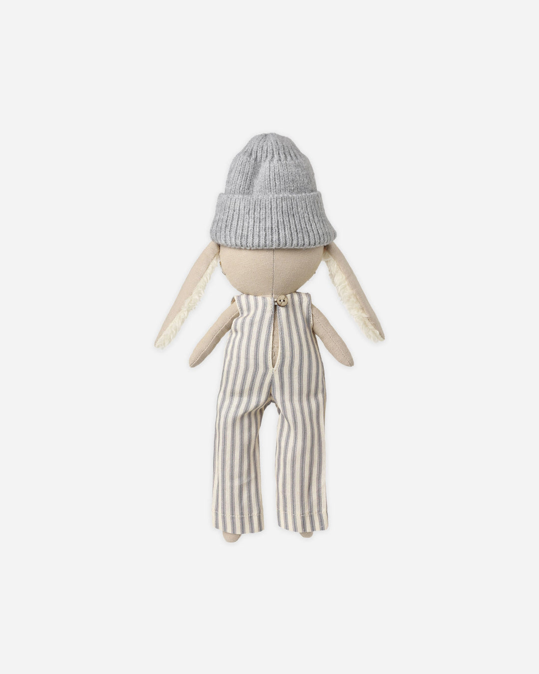 A handmade doll with a knitted gray beanie, cream fabric skin, and cream faux fur ears, wearing cream and gray vertically striped trousers, photographed against a solid off-white background.