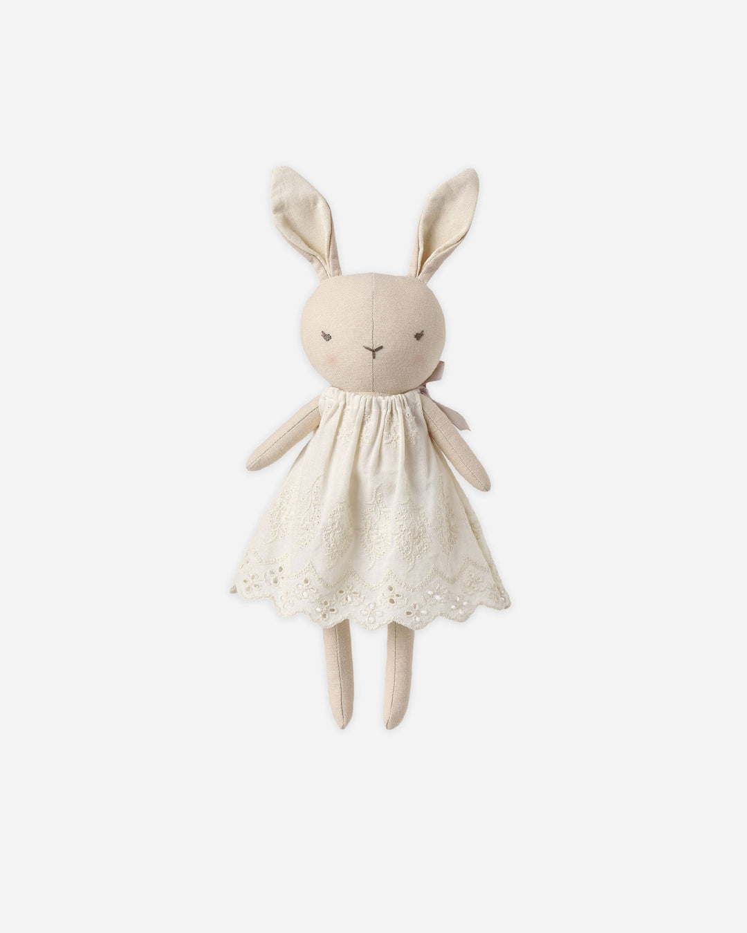 A cream-colored fabric bunny plush toy wearing a matching embroidered dress, centered on a light gray background.