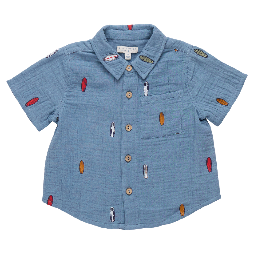 Blue children's shirt with decorative elements on a white background