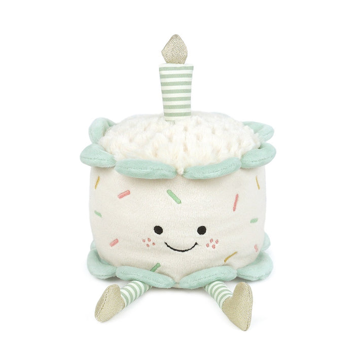Plush toy shaped like a birthday cake with a candle on a white background