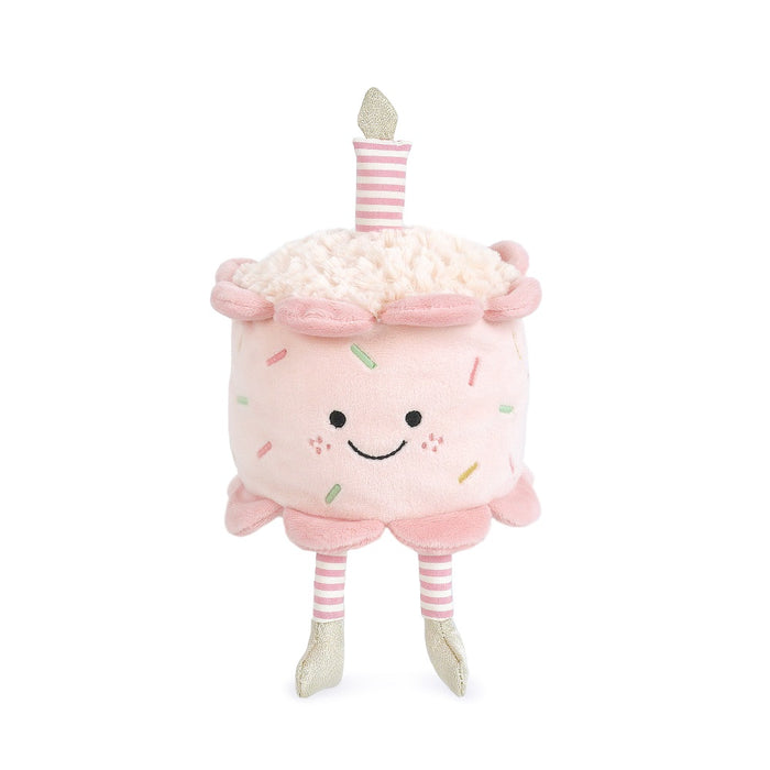 Plush toy resembling a birthday cake with a candle on a white background