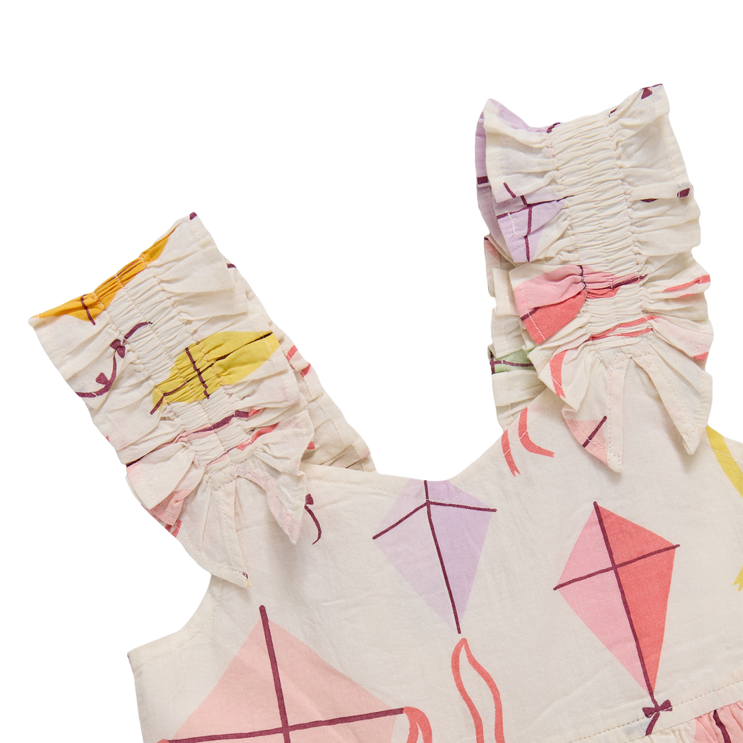 Children's dress with geometric kite pattern and matching headband on a white background