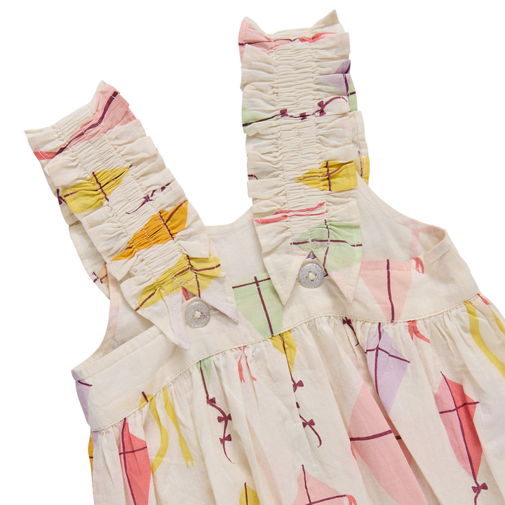 Back of Children's dress with colorful geometric pattern on a white background