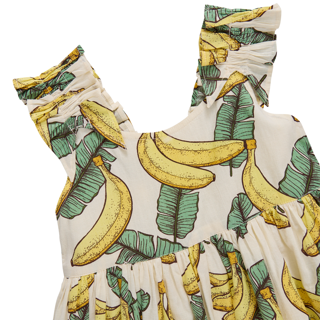 close up of the Dress with banana and leaf pattern on a white background