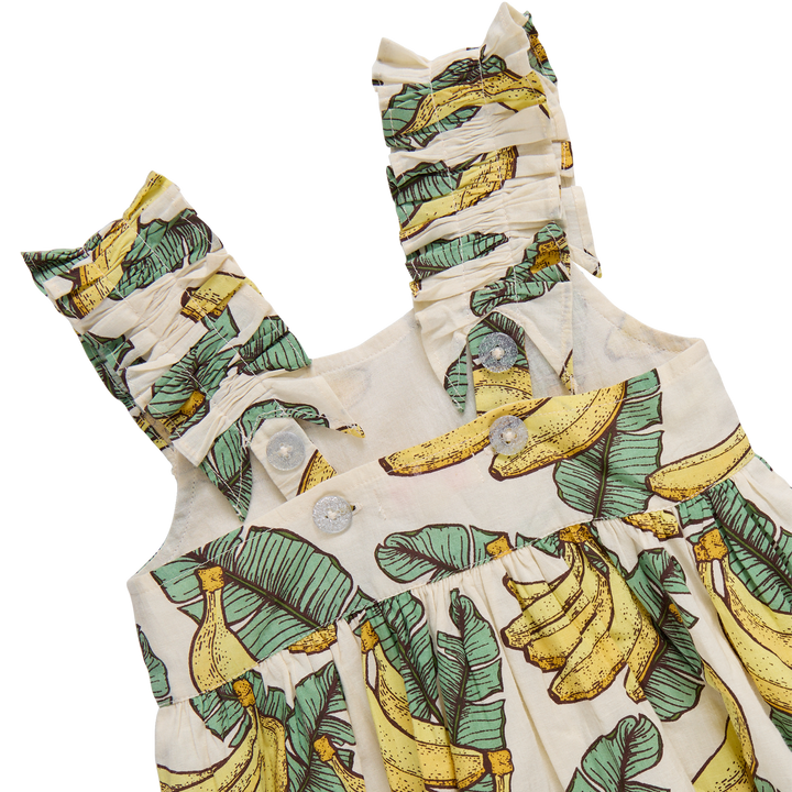 Baby romper with banana and leaf pattern on a white background