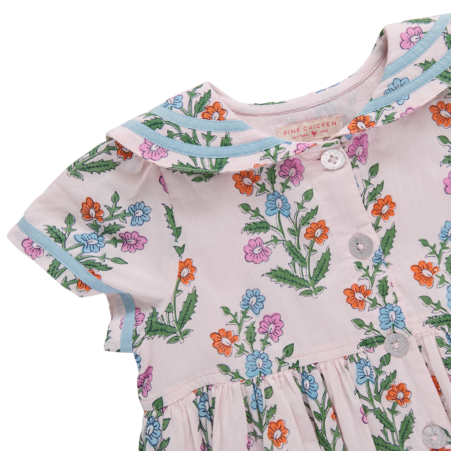 Baby dress with floral pattern on a white background