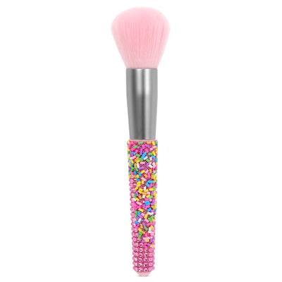 single makeup brush with pink bristles and a pink rhinestone handle with sprinkle all over the handle