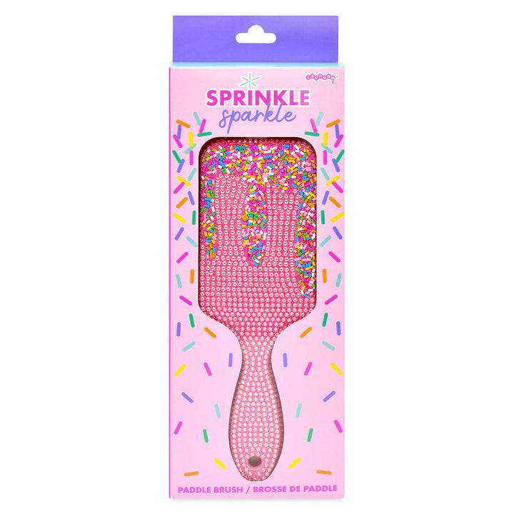 pink hair brush with sprinkles on it and tiny pink pearls. 