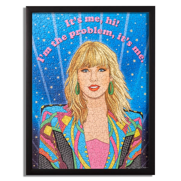 Taylor swift puzzle. Big picture of her face. She is wearing  colorful blazer and her hair is down. The saying reads " It&