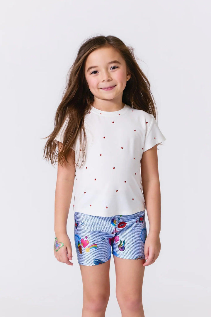 young girl wearing a tee shirt with ladybugs embroidered on it. short sleeve and white color 