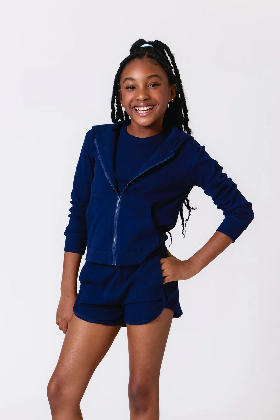 young girl modeling the navy ribbed hoodie with matching shorts 