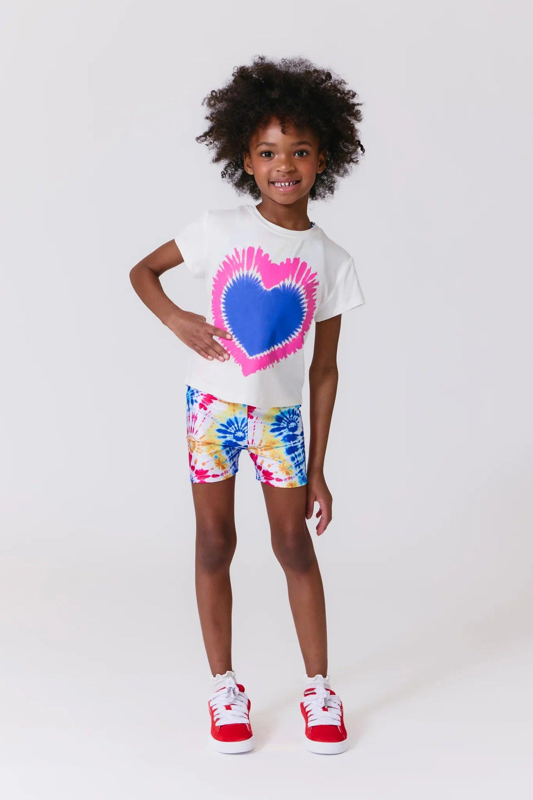 biker shorts with bursts of color in a tie dye effect: red, yellow, blue 