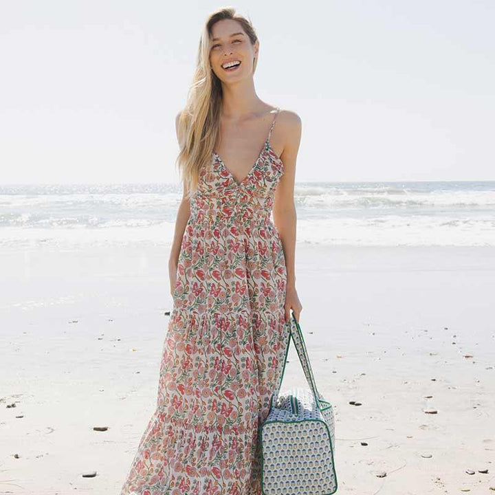 woman modeling the butterfly vines dress while standing on the beach 