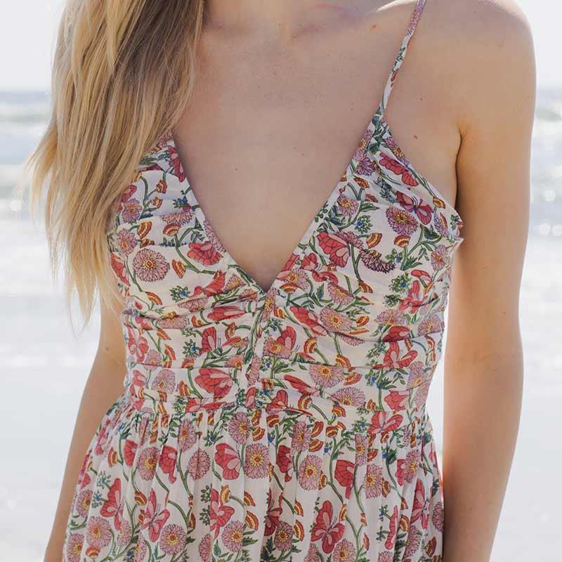 close up of the womens dress in the butterfly vines print, v at the neck and thin straps. 