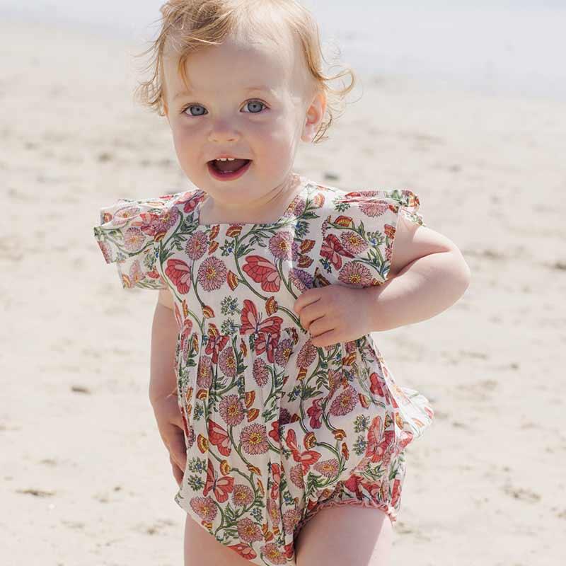 baby modeling the butterfly vines bubble with ruffles at the shoulder and snaps at the bottom of the bubble. 