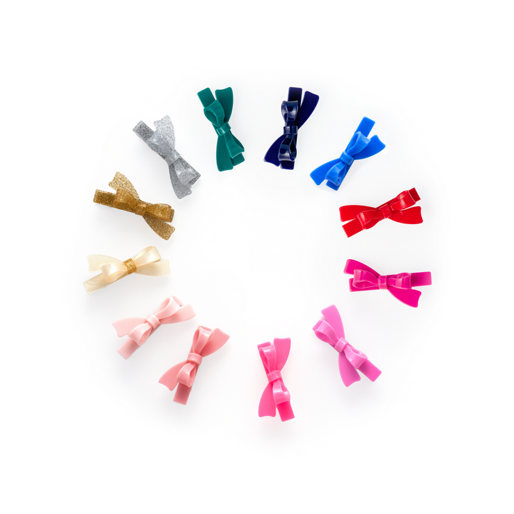 Colorful hair bows arranged in a circular pattern on a white background
