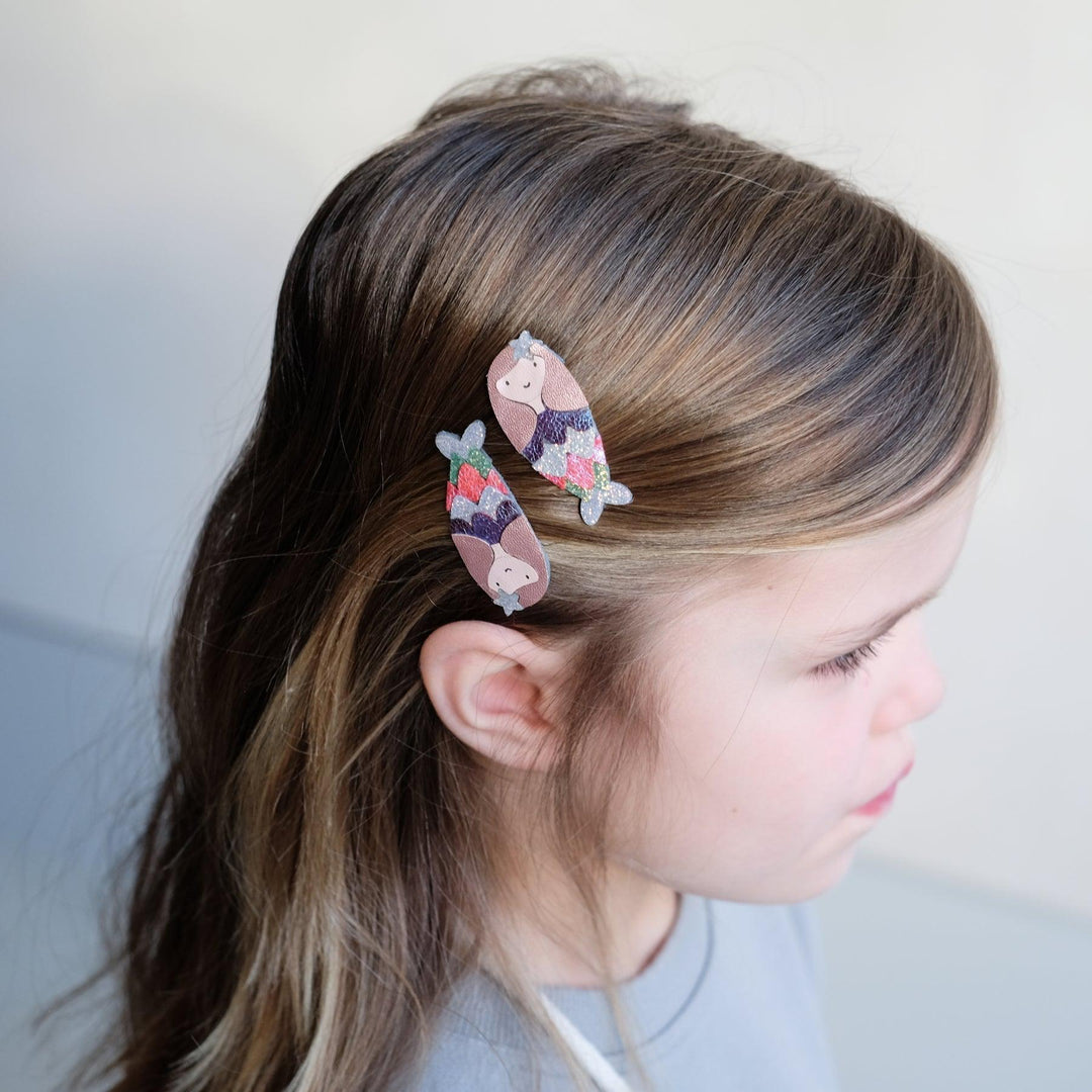 mermaid clips in the Little girl's hair. 