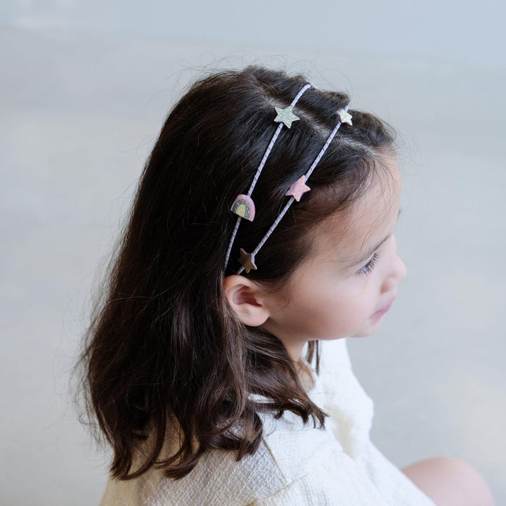 little girl with double headband in her hair. 