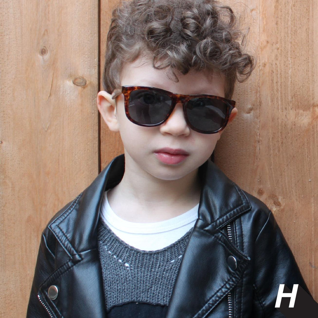 little boy modeling the weefarer style sunglasses with tortoise shell frames. 