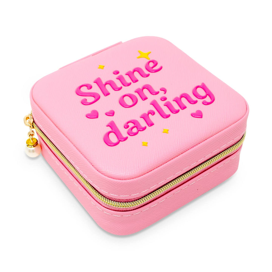 Pink jewelry case with 'Shine on, darling' text on a white background