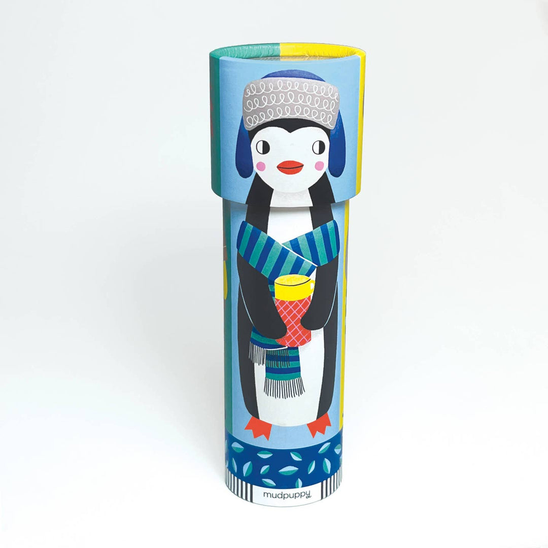 Kaleidescope top with a Penguin character in a colorful hat and scarf on a cylindrical packaging with 'Mudpuppy' branding.