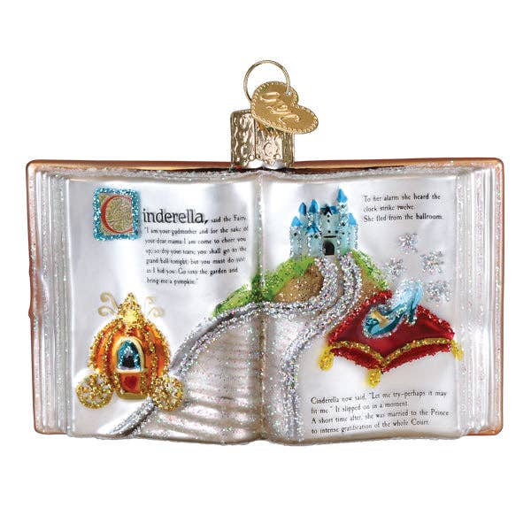 Decorative ornament shaped like an open book with Cinderella-themed illustrations on a white background.