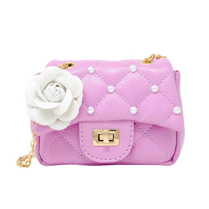 lavender quilted handbag with pearl studs and white flower on flap with gold hardware and gold chain link strap