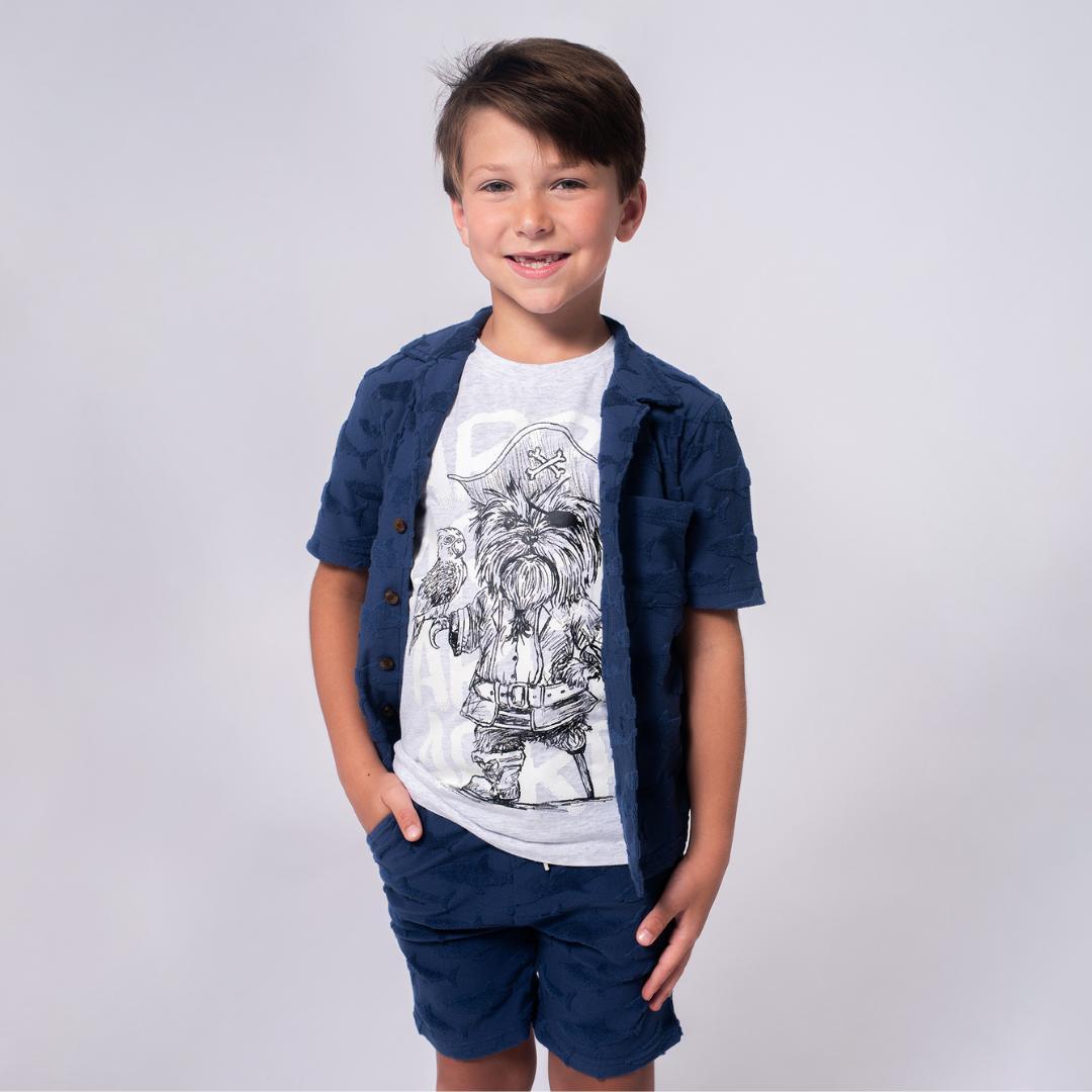 boy wearing a tee with a dog wearing pirate hat 