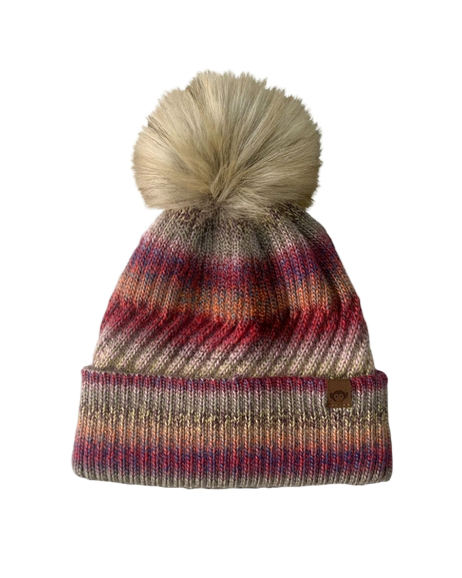Multicolored striped beanie with a pom-pom on a white background