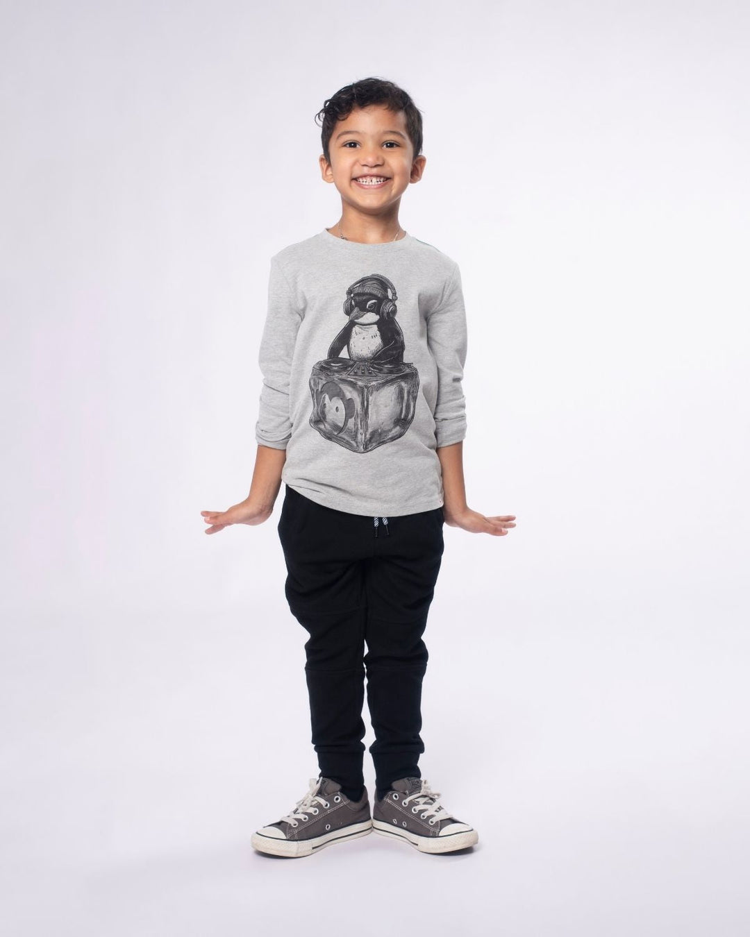 Child wearing a gray sweatshirt with a graphic design on a white background