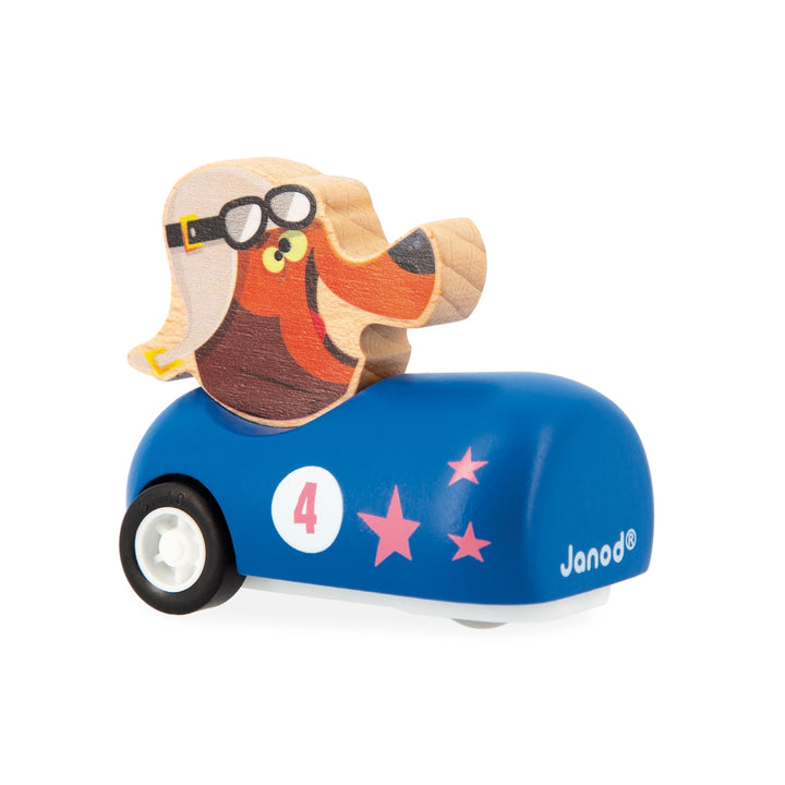 Wooden toy dog on a blue car with star design, featuring the brand 'Janod'.