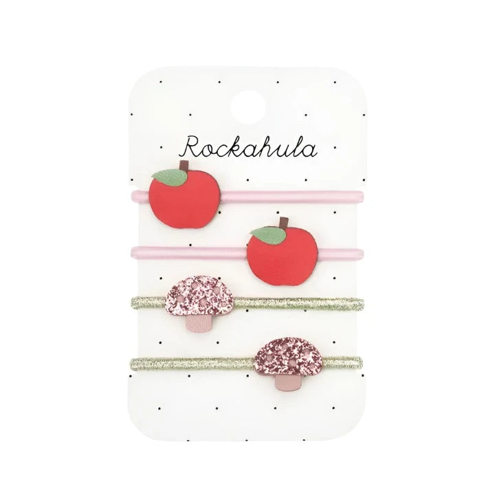 4 hair ties total, 2 pink with red apples on them and 2 gold with pink glitter toadstools on them. 