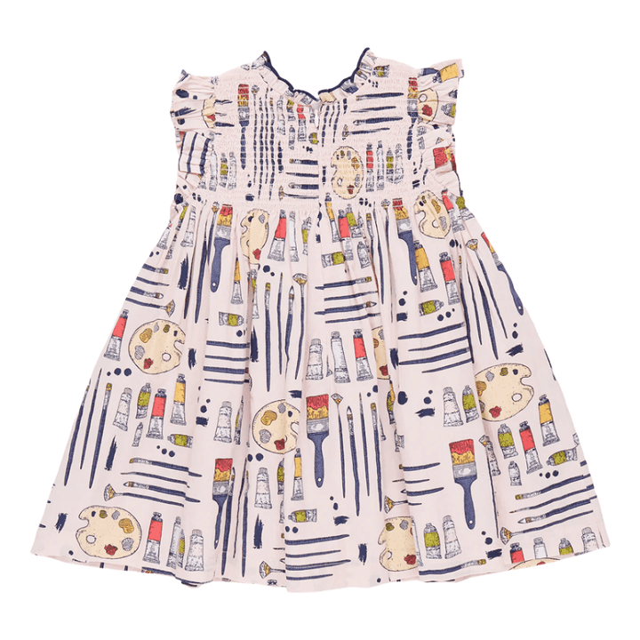 This is the back view of the dress. The dress has a light pink background There is a painter themed print all over the dress: paint brushes, paint, paint palette.