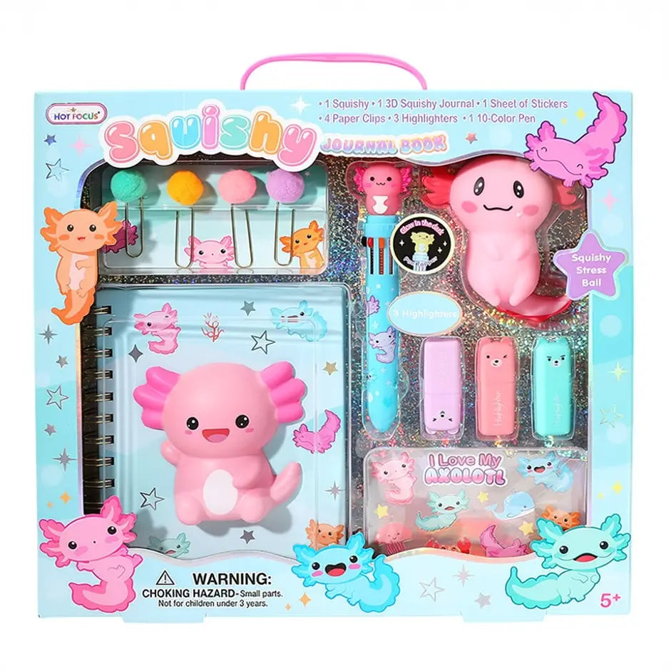 A children's squishy toy set in a light blue illustrated box with a pink cartoon creature theme. The set includes a squishy journal, stickers, paper clips, highlighters, a 10-color pen, and a stress ball, all decorated with pastel pink, blue, and orange characters.
